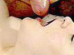 This is the slowest ejaculation you'll ever see. The hotty is lying on her back licking and sucking a guy's cock while this chab lazily jacks off. Cum leaks into her throat a not many drops at a time.